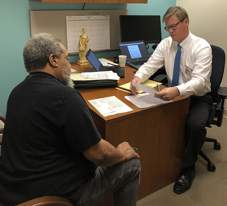 Attorney reviewing client's records with client